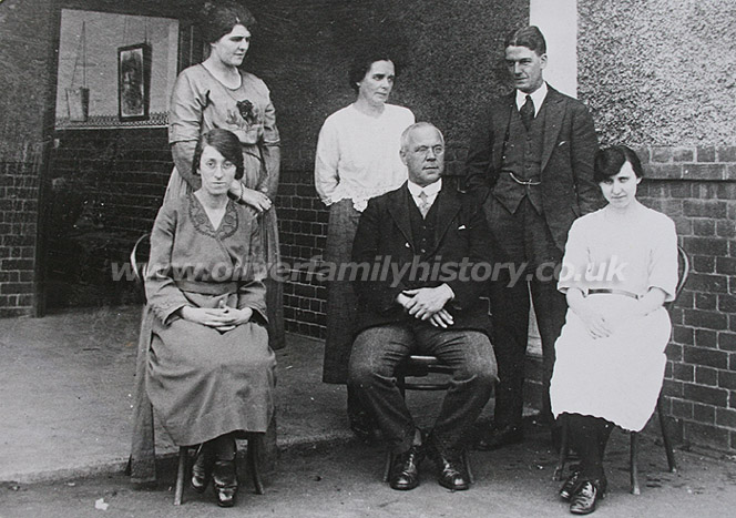 Circa. 1900-1930. This is a photograph of Frederick Charles Sommerton b.1870 (seated, centre) and his wife Jessie (nee Russell, standing centre). Frederick is the son on Harriet and Charles Sommerton (see Workhouse Lives article) and he and his wife Jessie were Headmaster and Headmistress of a school in Toddington, Bedfordshire.